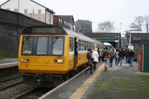 A crowd of passengers disembark from 142052s arrival at 1239 from Liverpool and head towards the waiting coach to continue their journey to Manchester - 27/12/06